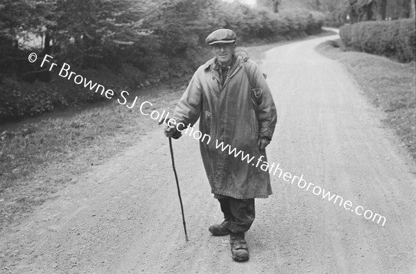 TRAMP WALKING ALONG ROAD